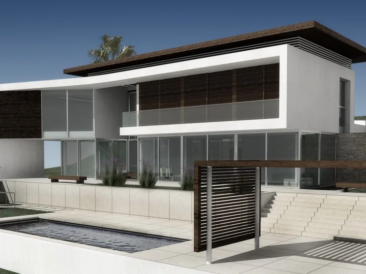 Fachada da Casa Amendoeiras com dois pavimentos e painéis verticais de proteção solar.