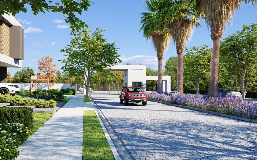 Alameda arborizada do Villa Natura Boulevard, com palmeiras, jardins e veículo.